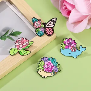 Enamel pins set featuring animal and succulent designs with butterfly, turtle, and whale