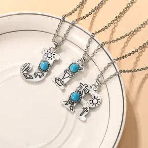 Vintage silver turquoise letter necklaces with bohemian carved charms on a ceramic plate