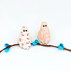 Set of two creative cartoon ghost enamel brooches in white and pink with floral patterns