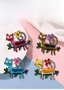 Detailed set of four colorful enamel cat brooches on floral branches with gold metal finish