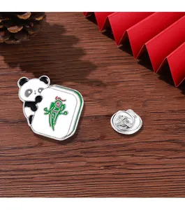 Detail of panda enamel pin with Mahjong tile showing metal back and butterfly clasp