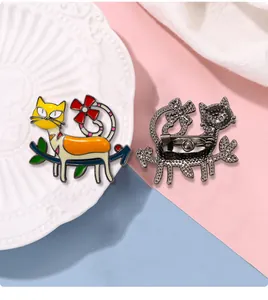 Detail of cute cat brooch with enamel finish showing front design and metal safety pin back