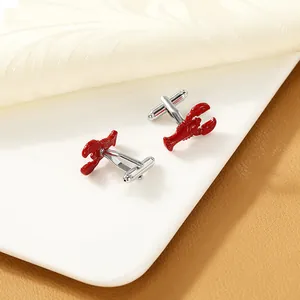 Macro detail of red lobster cufflinks with silver metal rotating T-bar closure