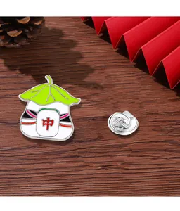 Detail of Mahjong panda enamel pin on dark wood background with red folding fan decor