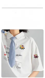 Detailed view of colorful cat enamel pins with floral designs pinned on a white shirt