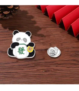 Detail of panda enamel pin holding mahjong and gold ingot on a Chinese style background