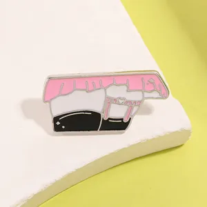 Detail of pink pleated skirt enamel pin with heart garter and smooth metal finish