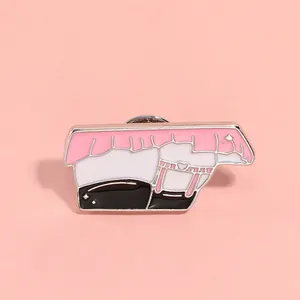 Close-up of pink enamel irregular brooch with feminine silhouette design and silver edges