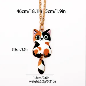 Cute calico cat pendant necklace with golden chain and dimension markings on white background