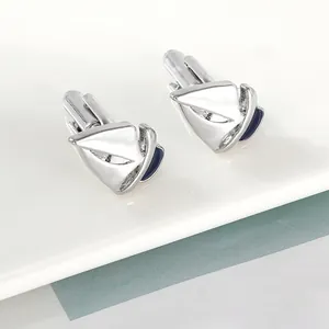 Elegant men's sailboat cufflinks featuring silver metal and dark blue enamel detail