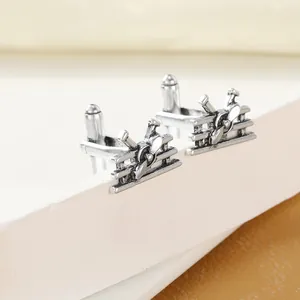 Detailed macro view of vintage silver biplane cufflinks with propeller and wing texture