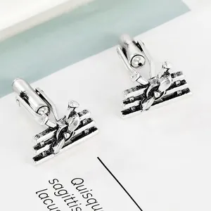 Detailed macro view of vintage silver airplane cufflinks with antique metal texture