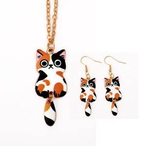 Detail view of cartoon calico cat jewelry set with necklace and hook earrings