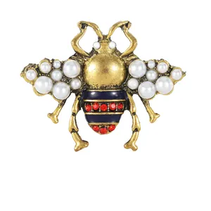 Vintage bronze bee brooch with white pearls, blue enamel and red rhinestones