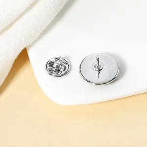 Polished silver alloy round brooch base with butterfly clutch back on white display