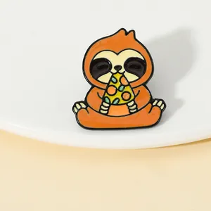 Close-up of a cute brown sloth enamel pin eating pizza on a white tray