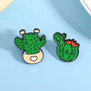 Detail of cute enamel pins featuring creative cat cactus designs on light blue background