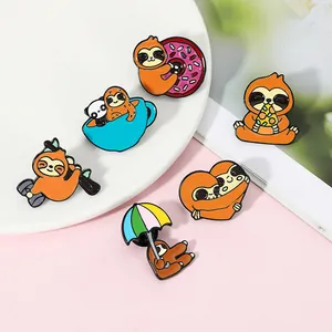 Detail of six creative brown enamel sloth pins showing various cute poses and high-quality alloy