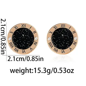 Detail view of round rose gold stud earrings with Roman numerals and star pattern