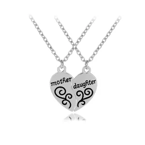Dettaglio di collane in argento a forma di cuore con incisioni Mother e Daughter