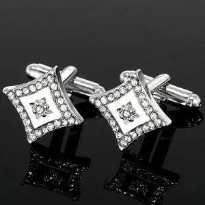 Macro view of square cufflinks with crystal border and star pattern on black surface