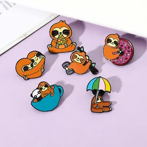 Detail of colorful enamel sloth pins set showing creative poses on lavender surface