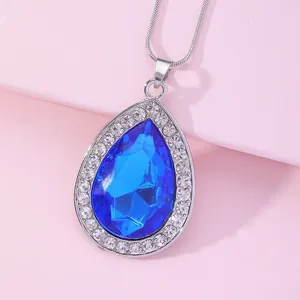 Detailed close-up of a blue pear-shaped crystal pendant necklace with silver chain