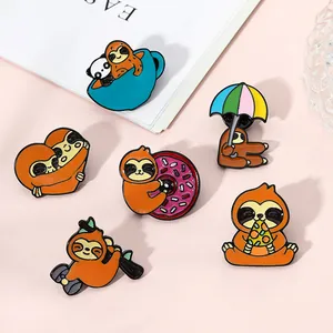 Detailed view of six cute cartoon sloth enamel pins set on a decorative pink background