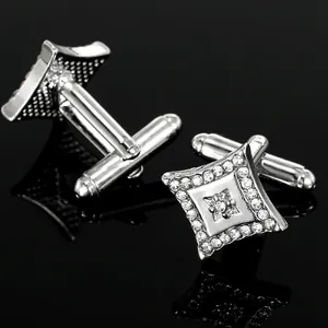 Macro detail of silver-tone cufflinks with sparkling crystals and bullet back closure