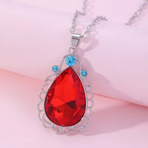 Princess amulet necklace with teardrop red gemstone and blue accents on silver chain
