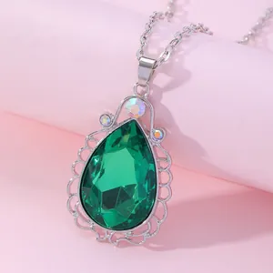 Detail of pear-cut green gemstone necklace with silver lace-edge metal frame and chain