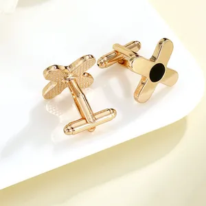 Polished gold-plated men's X-shaped cufflinks with black enamel inlay in a classic business style