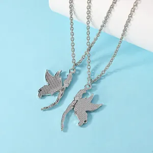 Fairy and angel wing necklace set with textured silver finish on blue background