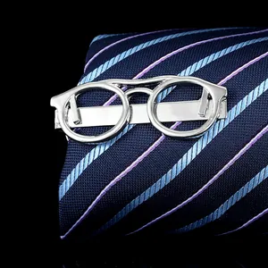 Close-up of silver glasses shaped tie clip on a navy blue striped necktie