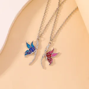 Detail of blue and pink enamel butterfly fairy pendants with silver chains