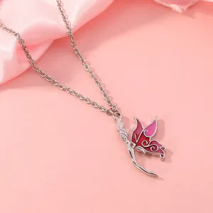 Detail of fairy butterfly pendant with pink enamel wings on silver metal chain