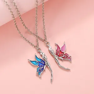 Detail of blue and pink enamel butterfly fairy pendants on delicate metal chains