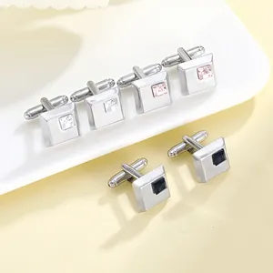 Detail of silver square cufflinks with crystal insets in white, pink and blue tones