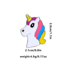 Detail shot of a small white unicorn enamel pin with size and weight measurement labels