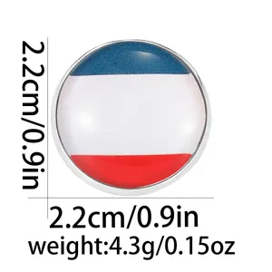 Detail of a 22mm round metal badge featuring red, white, and blue stripes under glass