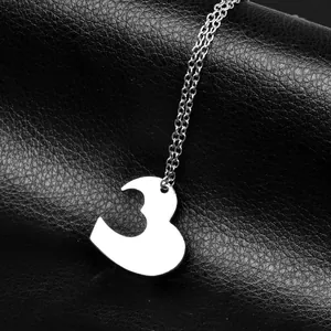 Polished silver heart pendant necklace with cutout number 3 on black leather background