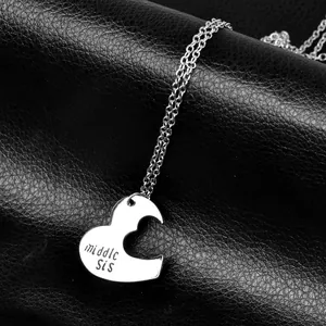 Detailed macro view of silver middle sis heart puzzle necklace on black leather