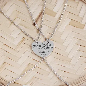 Detailed view of a three-piece heart puzzle necklace set for Mom and sisters