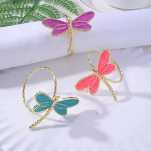 Detailed view of elegant dragonfly napkin rings with colorful enamel and gold finish