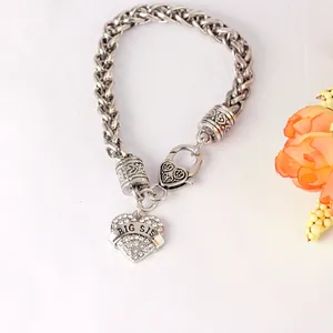 Detail of silver heart pendant with Big Sis engraving and sparkling white rhinestones