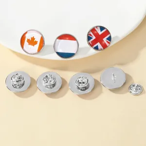 Detailed close-up of round metal national flag badges with secure butterfly clutches