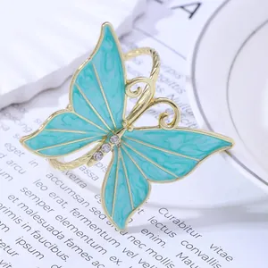 Macro detail of butterfly napkin ring with light blue enamel and sparkling rhinestones