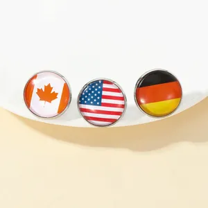 Detail view of round national flag pins featuring Canada, USA, and Germany designs