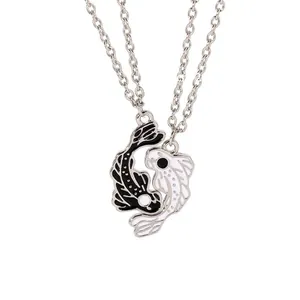 Detail shot of Yin Yang Koi fish necklaces with black and white enamel finish