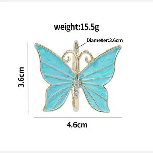 Golden butterfly napkin ring with blue enamel wings and sparkling crystal rhinestones